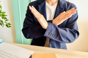 バツの仕草をする男性